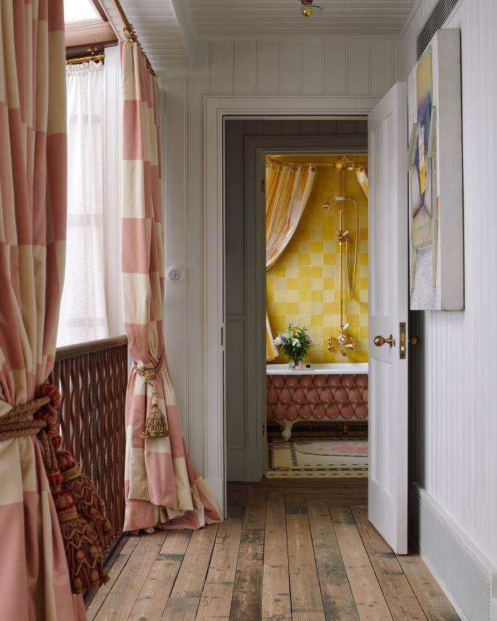 Buchanan Studio velvet curtains on the fourth-floor landing, with a view through to the “silicone boob” bath