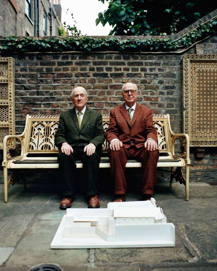 Gilbert Proesch (left) and George Passmore with a model of The Gilbert & George Centre