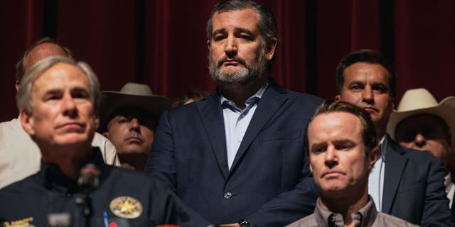 Sen. Ted Cruz, R-Texas, looks on as Texas Gov. Greg Abbott speaks during a press conference at Uvalde High School on May 25, 2022 in Uvalde, Texas.