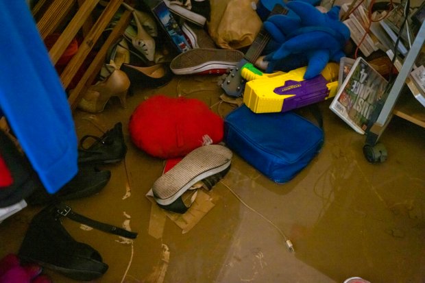 Shoes, video games, toys, stuffed animals and other belongings lay...