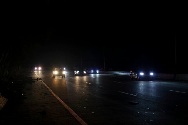 Drivers drive on a dark road after the passing of...