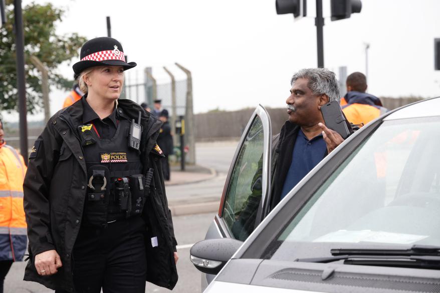A picture of Lancaster talking with a person on the street.